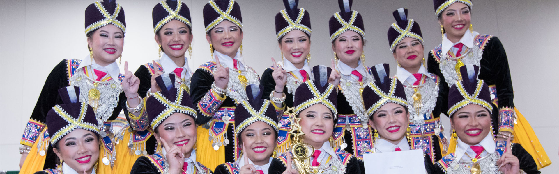 A group of Hmong traditional dancers posing